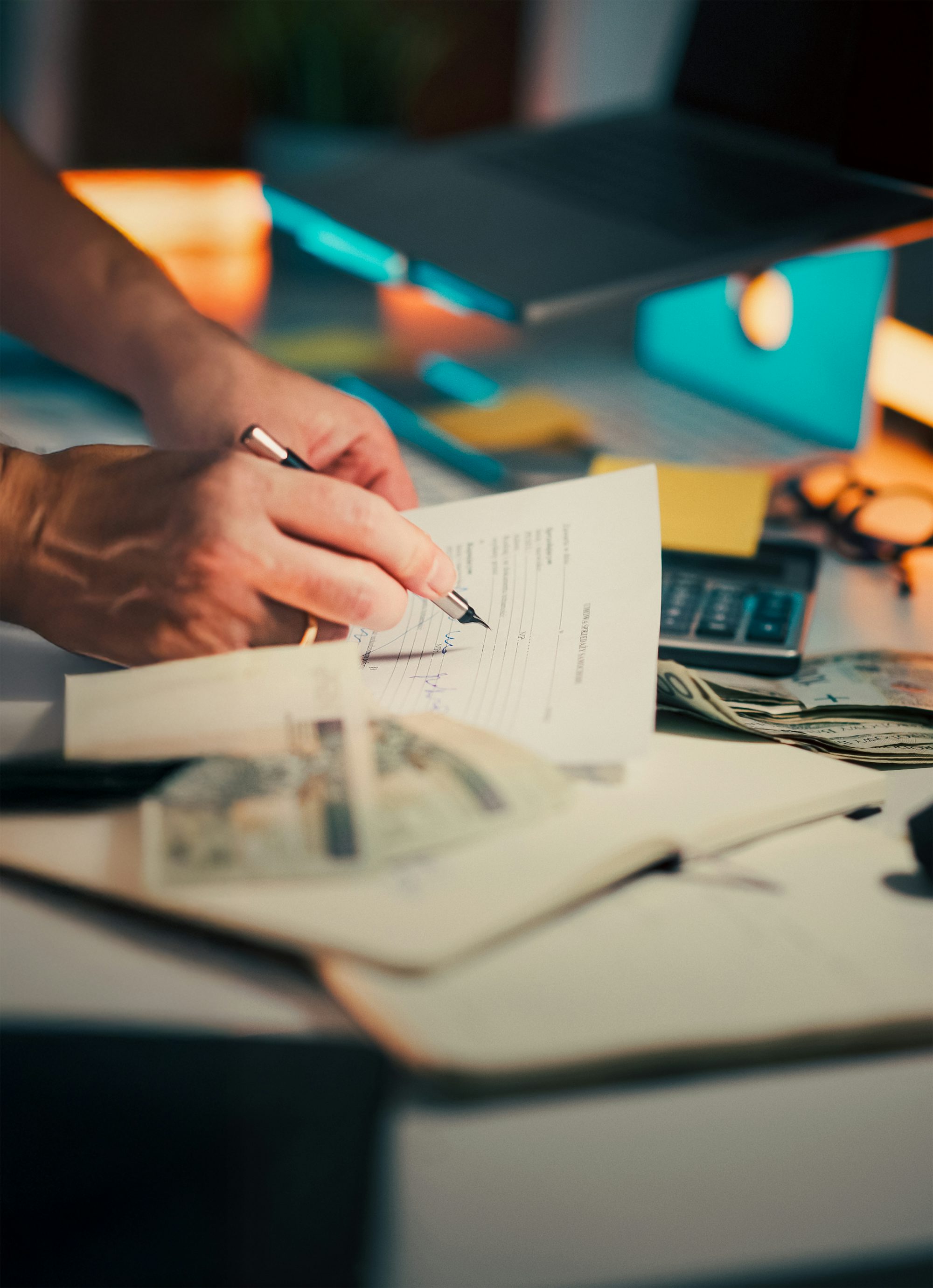 Hands signing a document