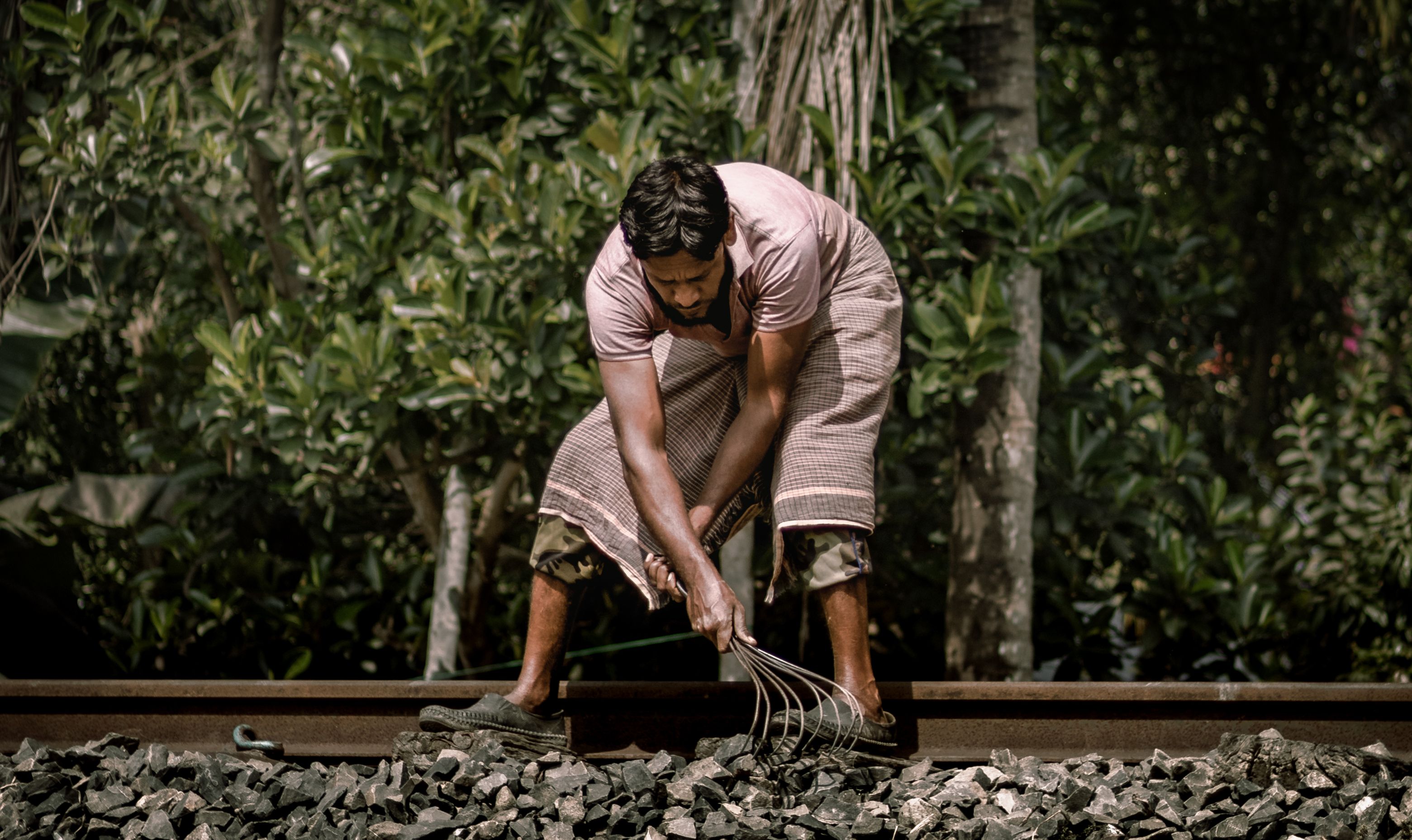 Worker inspecting railway tracks